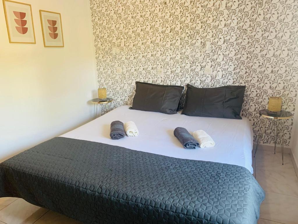 a bedroom with a bed with two pillows on it at Skopelos Inn in Stafylos