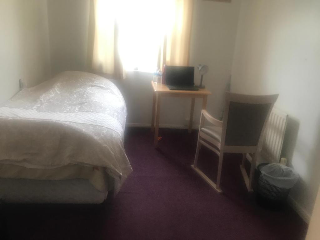 a bedroom with a bed and a desk and a television at 31 Stonelea court in Meanwood