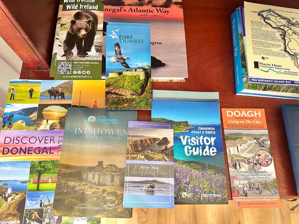 a bunch of books sitting on a table at Whitestrand B&B in Malin Head