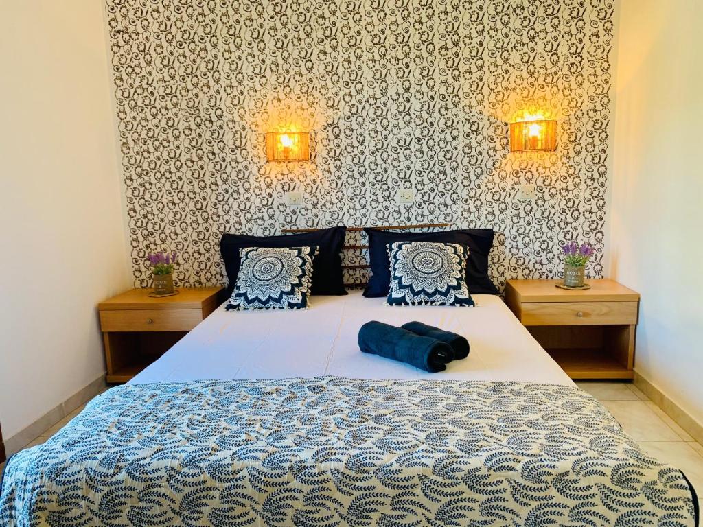 a bedroom with a large bed with two night stands at Skopelos Inn in Stafylos