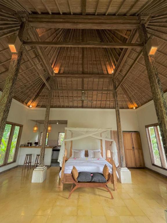 a bedroom with a bed in the middle of a room at Thani Villa Ubud in Ubud