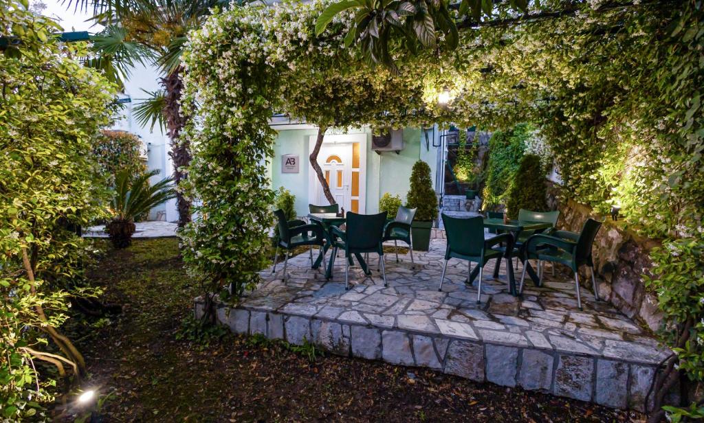 a patio with a table and chairs under an arch at Apartmani Bijelic HN in Herceg-Novi
