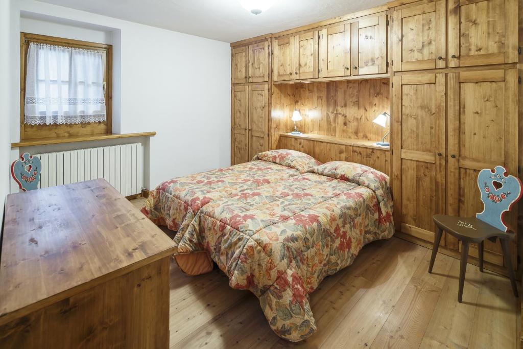 sypialnia z łóżkiem i stołem w obiekcie Villa Lacedel - Stayincortina w mieście Cortina dʼAmpezzo