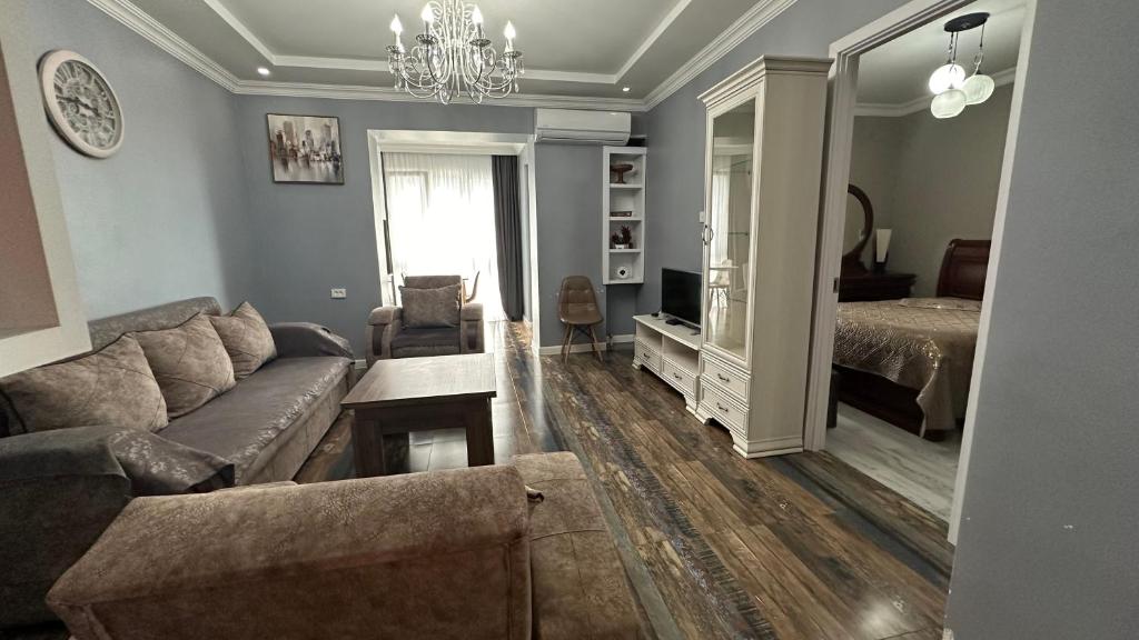 a living room with a couch and a bed at Tatas Place in Batumi