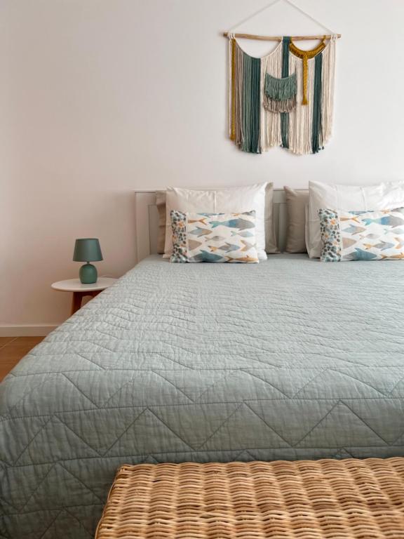 a bedroom with a large bed with pillows at Porto Santo Happy Place in Porto Santo