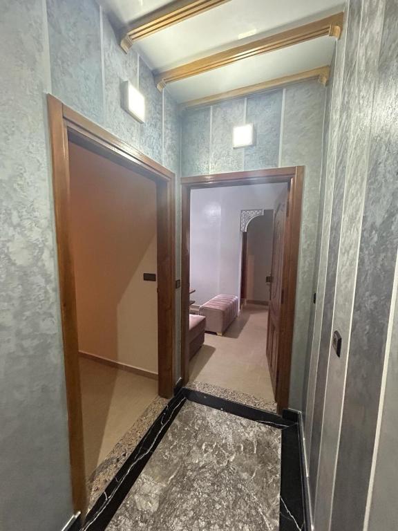 a room with a hallway with a door and a bedroom at Appartement à Houma, proche Port Tanger Med in Dalia