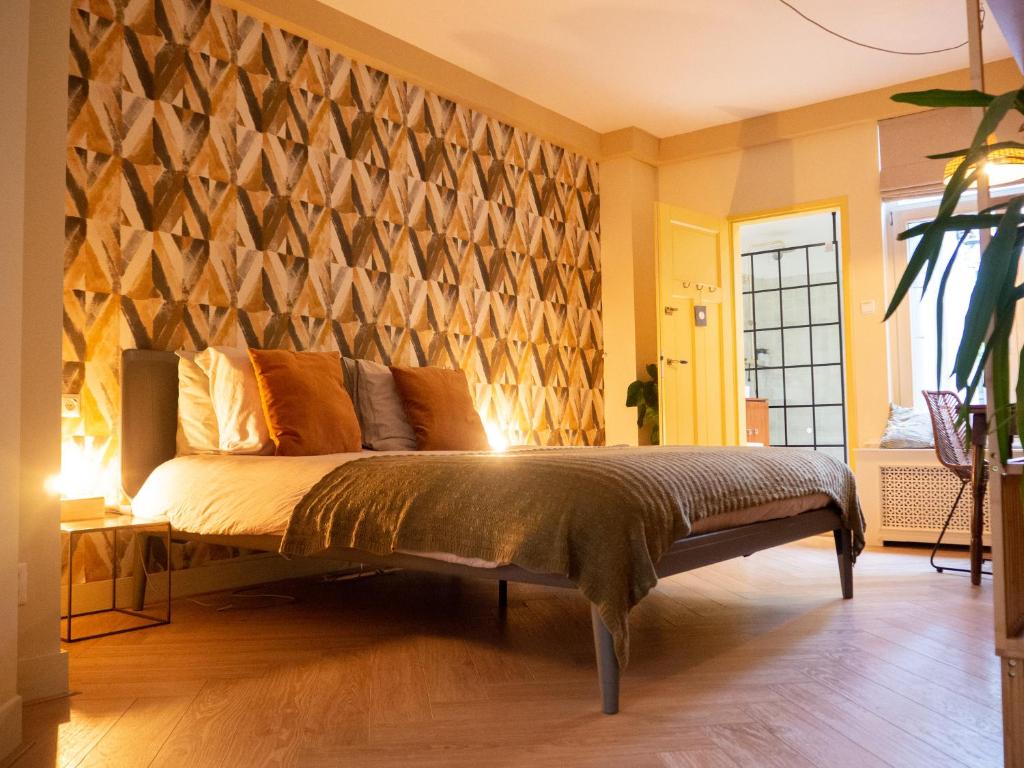 a bedroom with a bed with a wooden wall at BnB 117 in Amsterdam