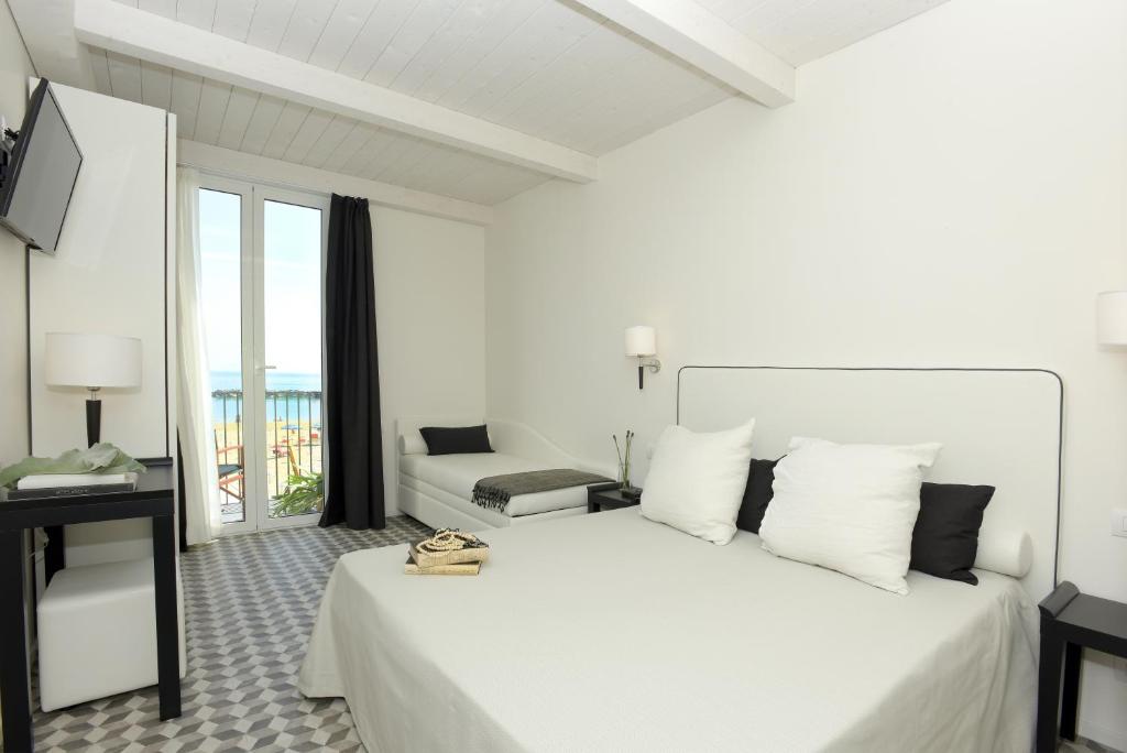 Postel nebo postele na pokoji v ubytování Hotel Capanni