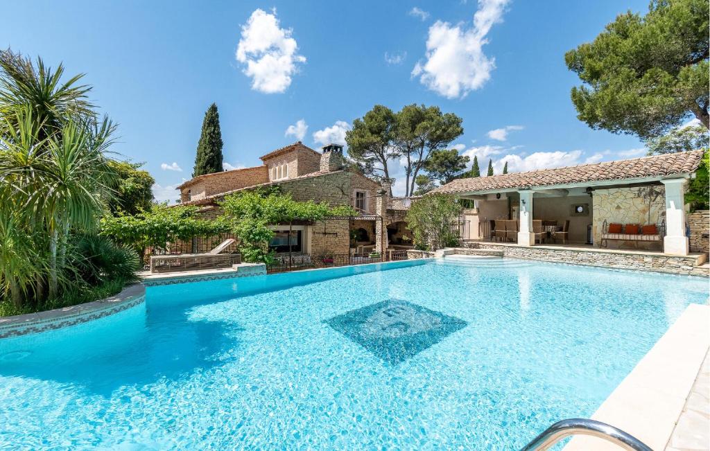 a swimming pool in front of a house at Amazing Home In Orgon in Orgon