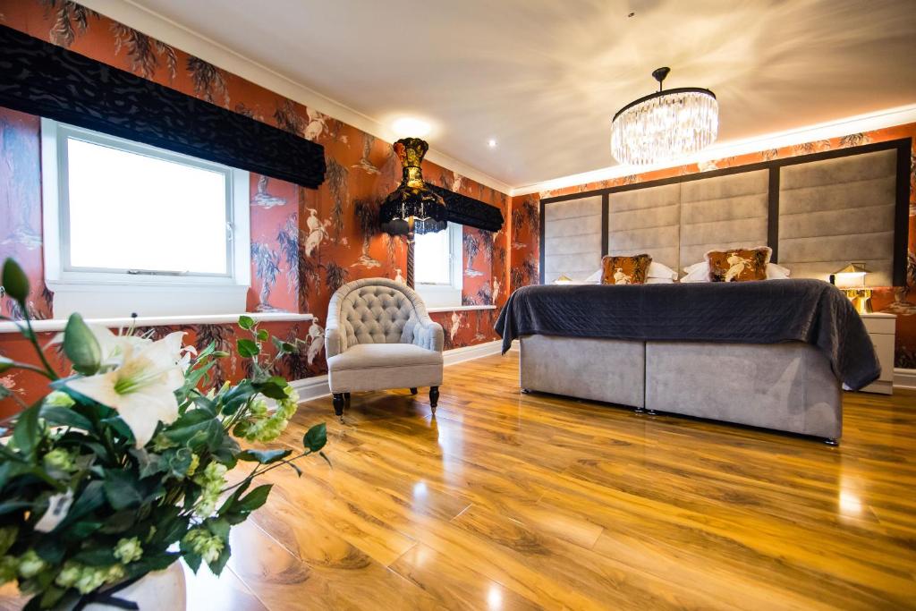 a bedroom with a bed and a chair at The Burgoyne in Reeth