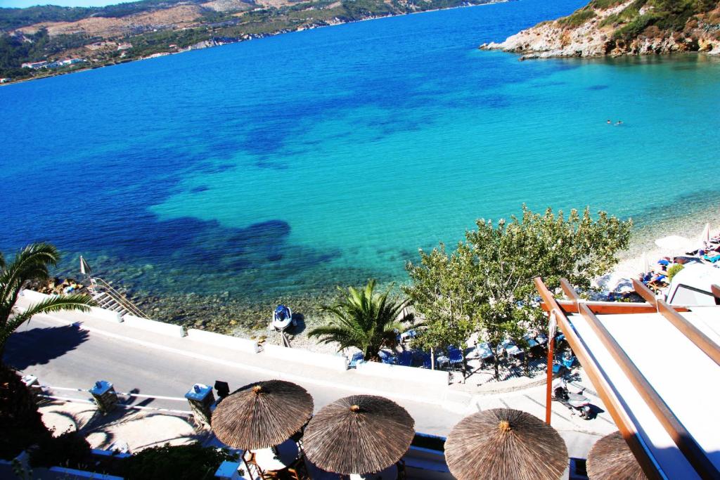 a view of a beach with umbrellas and the ocean at Samos Bay Hotel by Gagou Beach in Samos