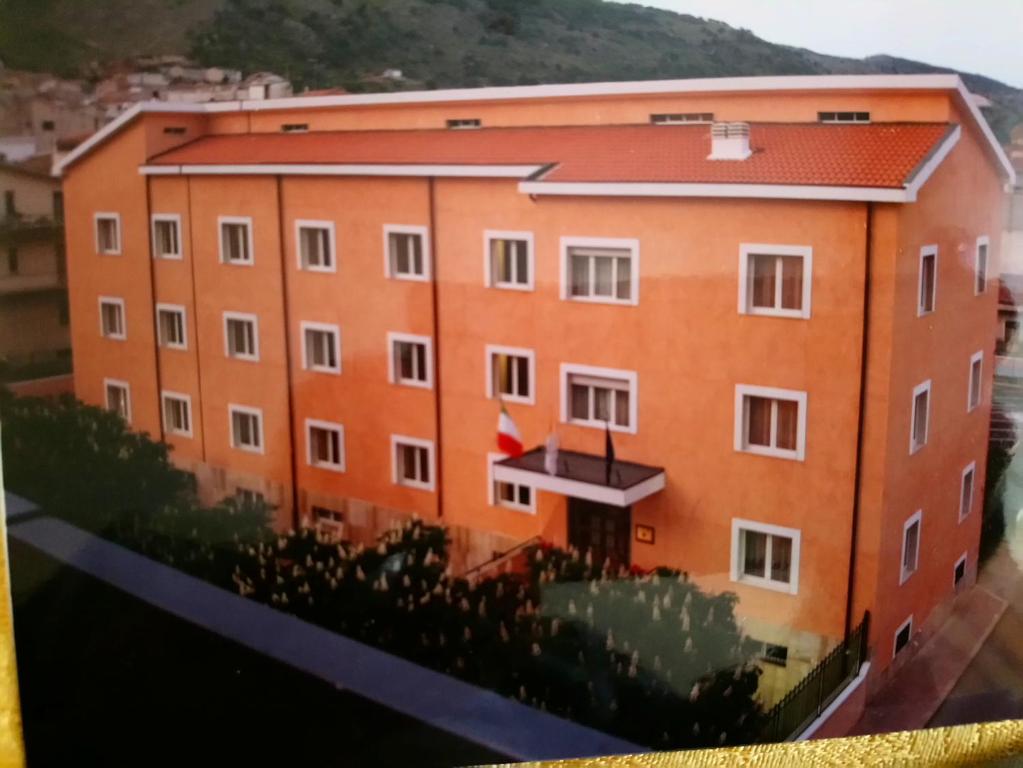 a large orange building with a red roof at casapaceebene in San Giovanni Rotondo