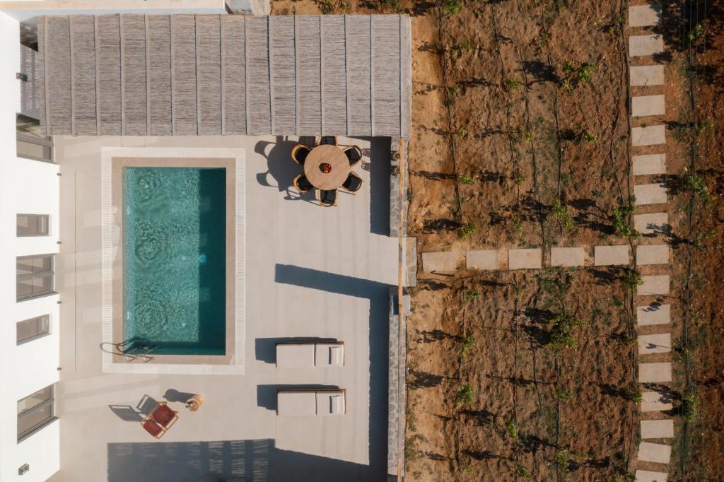 an overhead view of a house with a swimming pool at Noble Pearl Villas Paros in Santa Maria