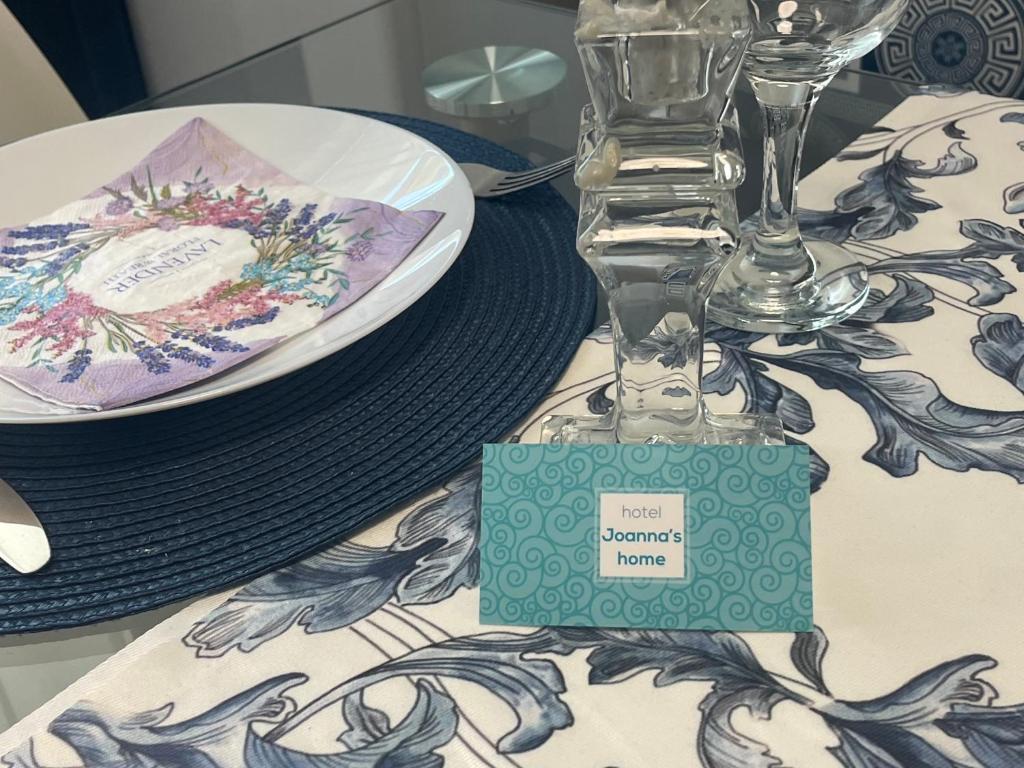 a table with a plate and a glass vase on it at Joanna’s home in Veliko Tŭrnovo