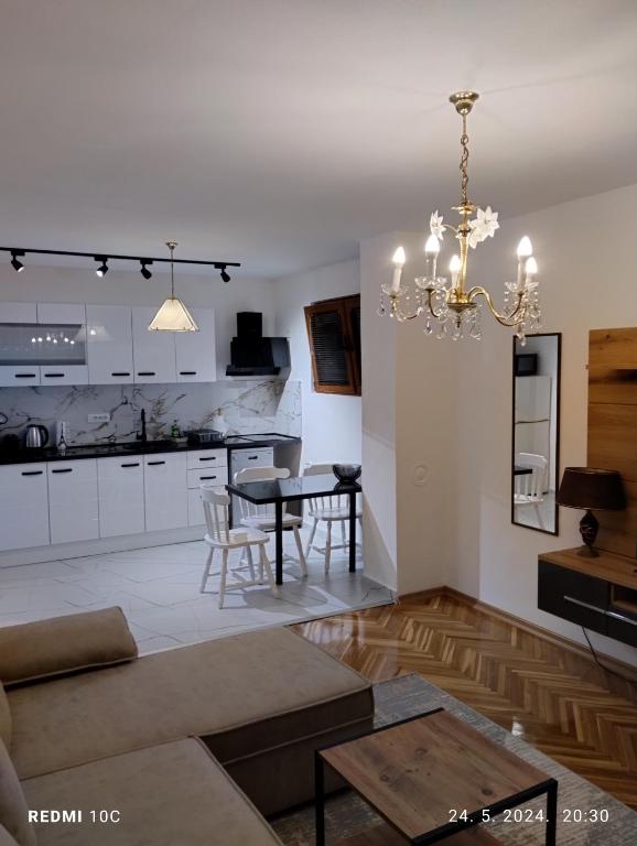 a living room with a table and a dining room at Apartments Natali in Bar