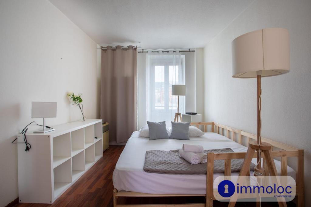 une chambre avec un lit blanc et une grande fenêtre dans l'établissement Acropolis Neighbourhood Studio, à Nice