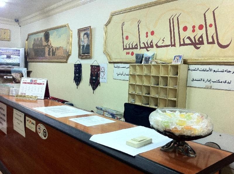 a shop with a counter with a counter top with aperature at Farah Hotel in Amman
