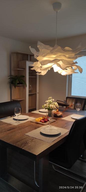 a wooden table with glasses and food on it at Lilli Flensburg Fewo in Flensburg
