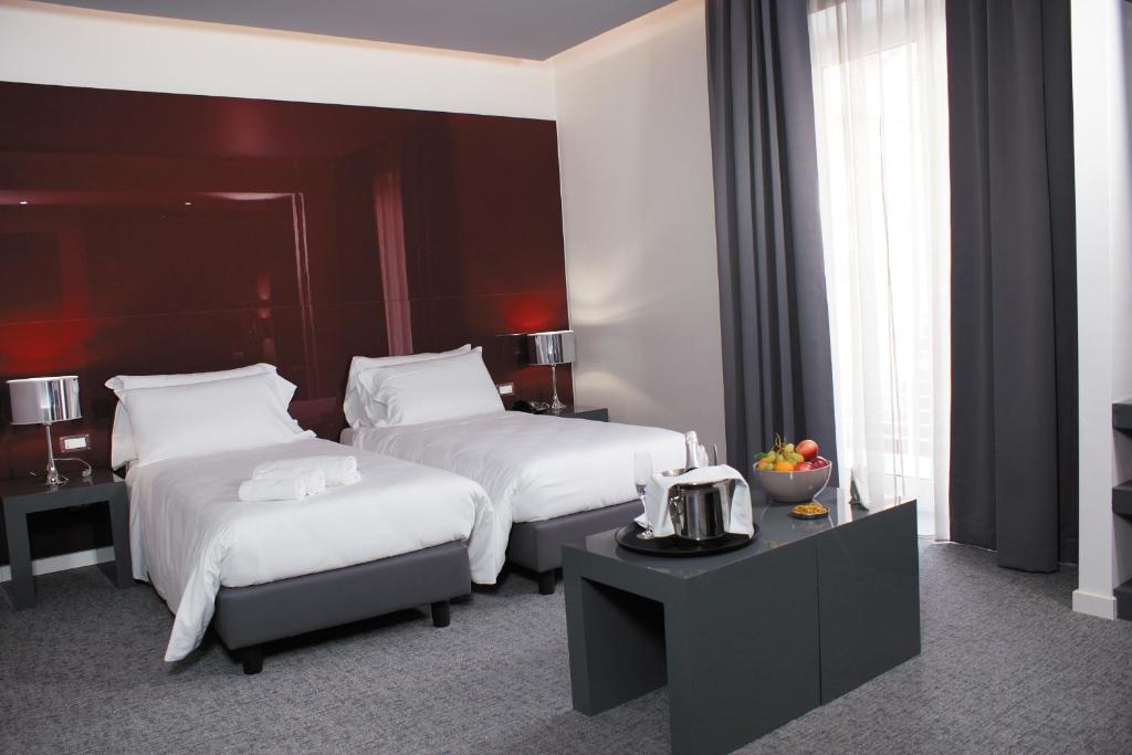 Postel nebo postele na pokoji v ubytování Hotel Leopardi