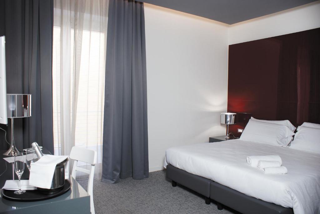 Postel nebo postele na pokoji v ubytování Hotel Leopardi