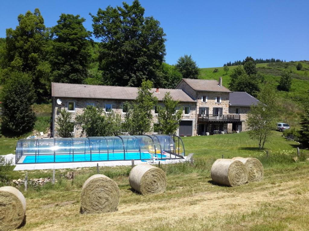 a playground in a field with hay bales at Le Moulinage Des Ruches in Saint-André-en-Vivarais