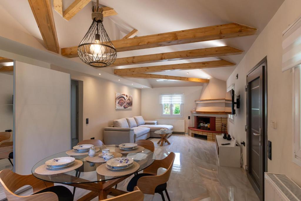 a kitchen and living room with a table and chairs at Villa Eden in Iraklitsa