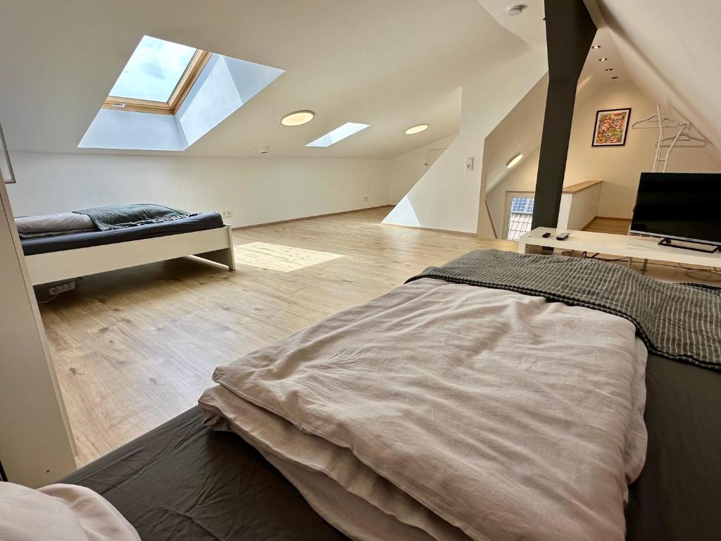 a bedroom with a bed in a room with a window at Rhein Quartier - Biebesheim in Biebesheim