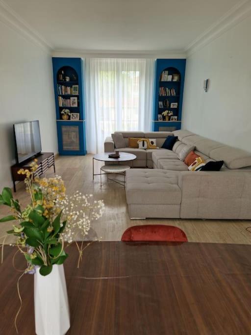 - un salon avec un canapé et un vase fleuri dans l'établissement Grande maison en Bords de Marne - 25 min de Paris, à Créteil