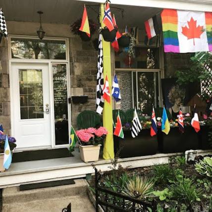 a house with flags on the front of it at Auberge PVT Hostel in Montreal