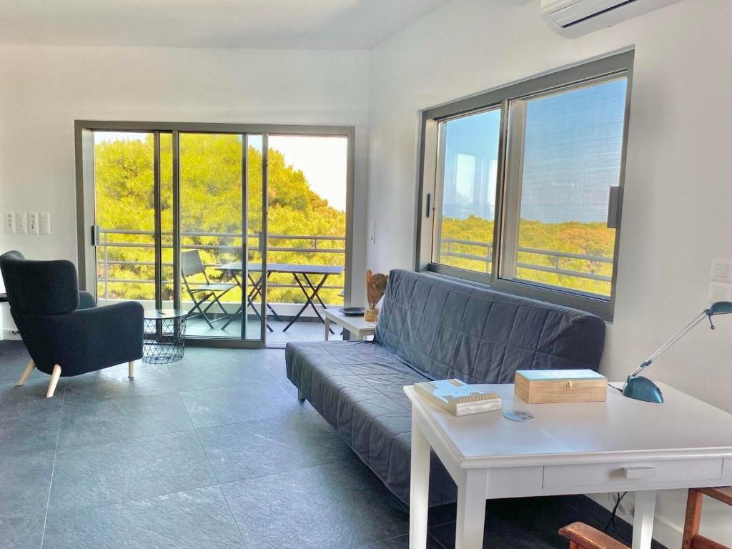 a living room with a couch and a table at P C Side NEST in Xylokastro