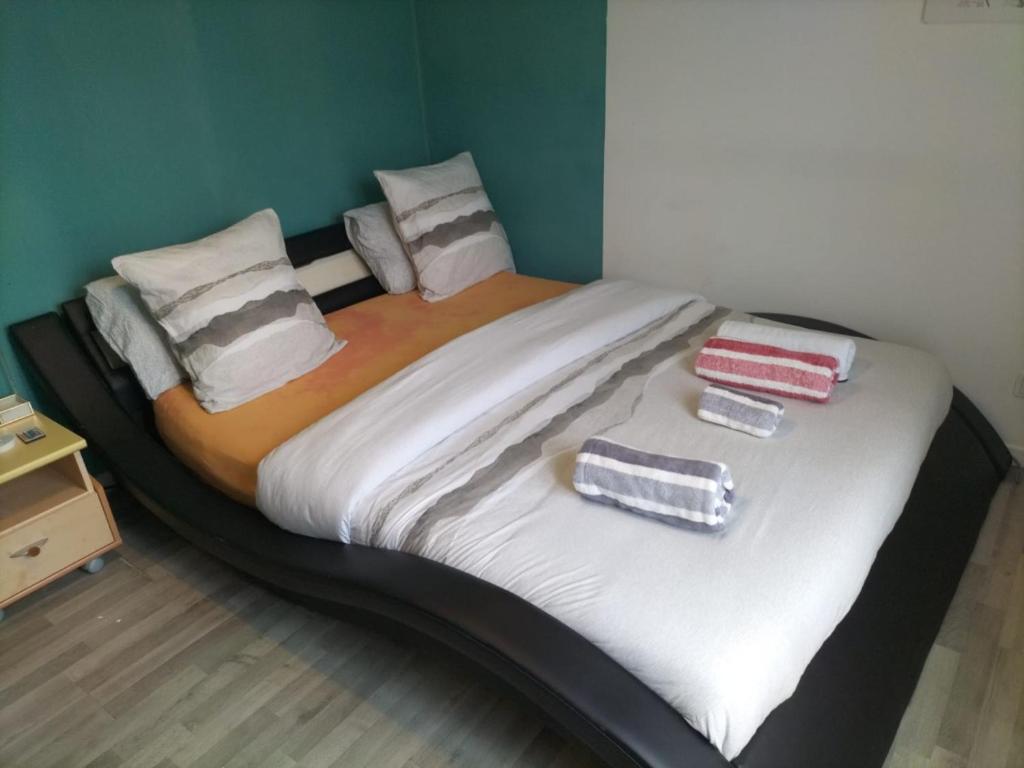 a large bed with two pillows on top of it at Chambre double à 10 minutes de Paris in Antony