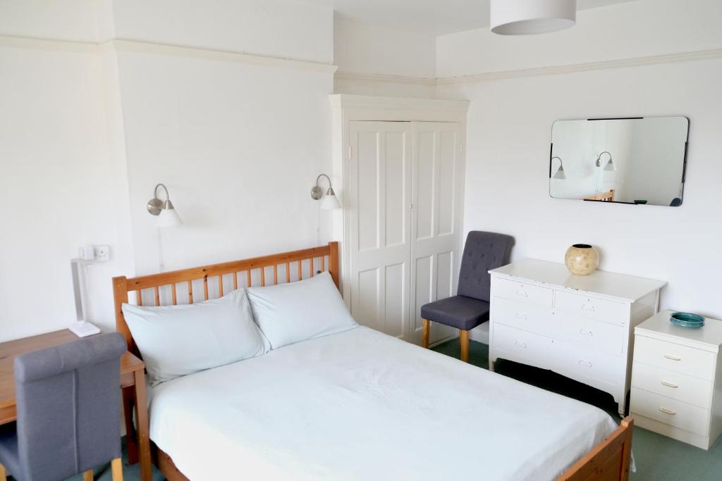 Schlafzimmer mit einem Bett, einem Schreibtisch und einem Stuhl in der Unterkunft Lynton Road in London