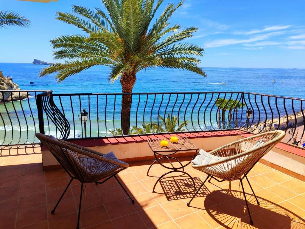a balcony with a table and chairs and a view of the ocean at Sea Views Benidorm Beach in Benidorm