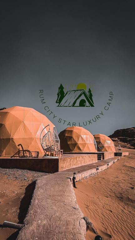 a group of domed buildings in the desert at Rum city Star LUXURY Camp in Wadi Rum