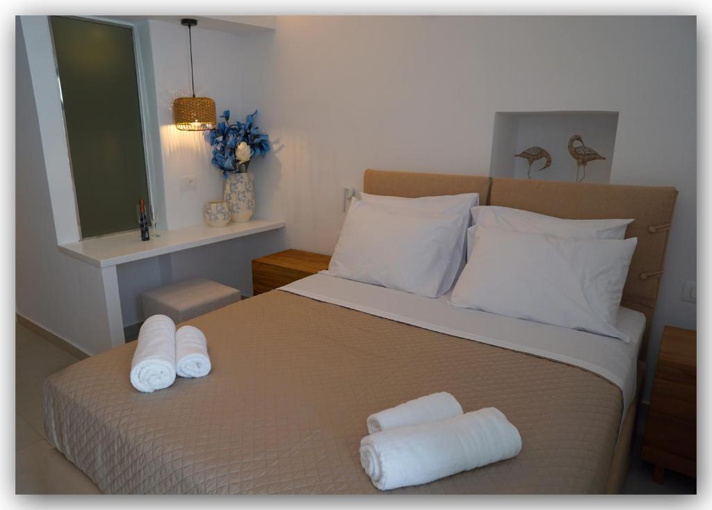 a bedroom with a bed with two towels on it at Katoi by Welcome Home in Mýkonos City