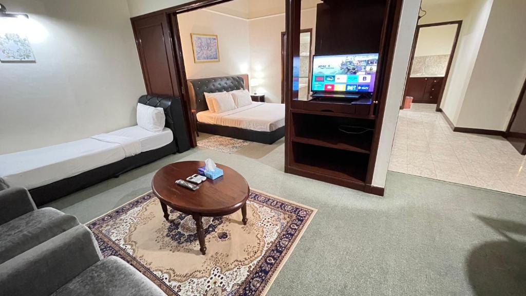 a living room with a couch and a coffee table at 100 Service suites At Times Square KL in Kuala Lumpur