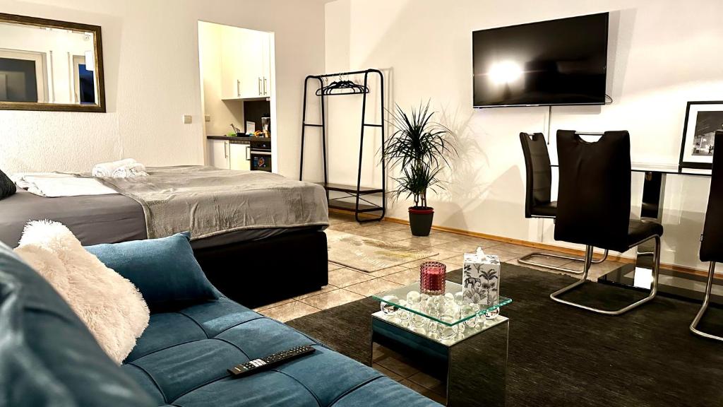 a living room with a couch and a tv at BeeFree Thermen und Golf3 I Free Parking I Balcony in Pocking
