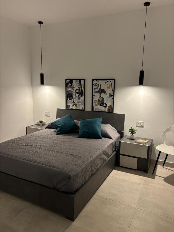 a bedroom with a large bed and a table at Home Sweet Home in Siracusa