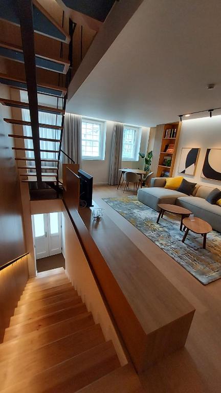 a living room with a staircase leading to a living room at Casa das Flores in Bragança