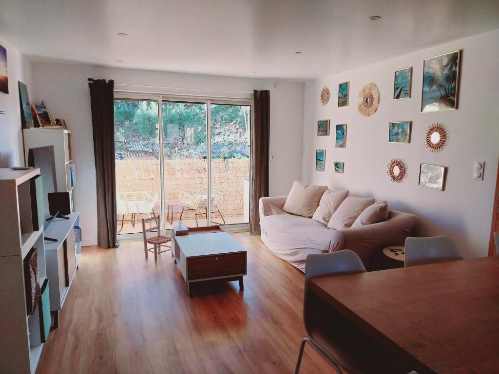un salon avec un canapé et une table dans l'établissement Appartement à 300m de la plage, à Fréjus