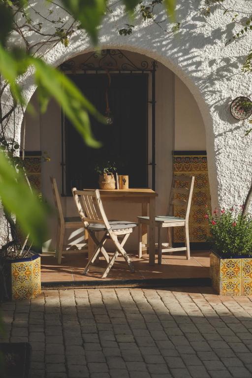 a table and two chairs on a patio at Casa con encanto in Corbera de Llobregat
