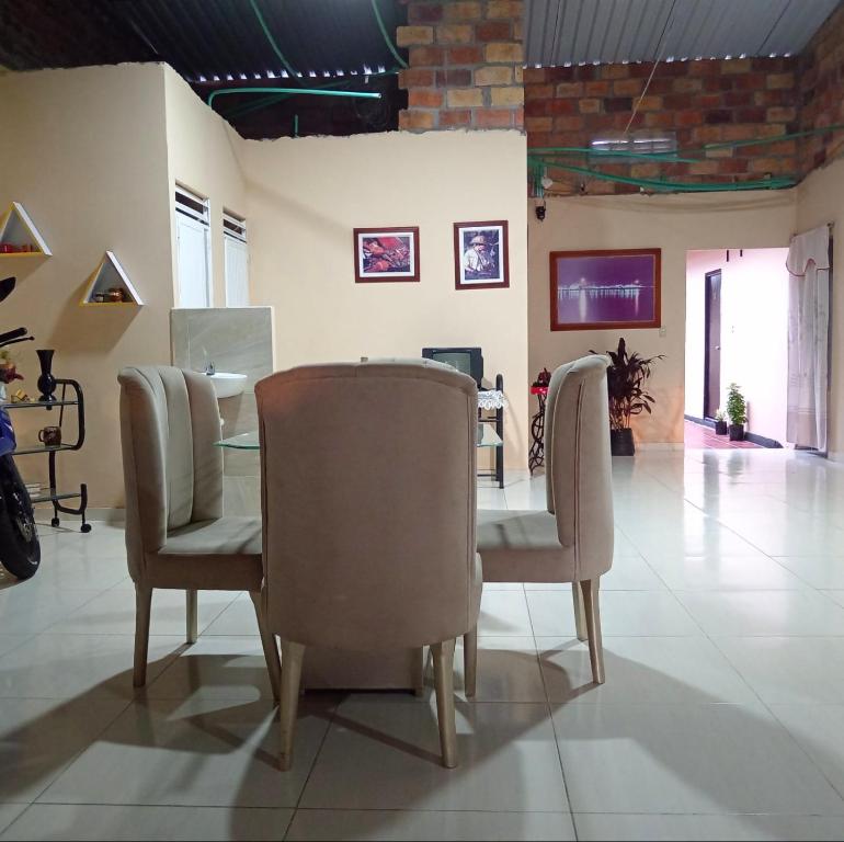 a dining room with a table and two chairs at Hotel Candilejas Serenity in Barrancabermeja