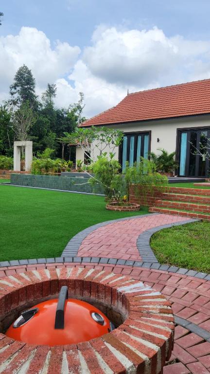 a brick fire pit in the middle of a yard at Mawarvilla jb in Johor Bahru
