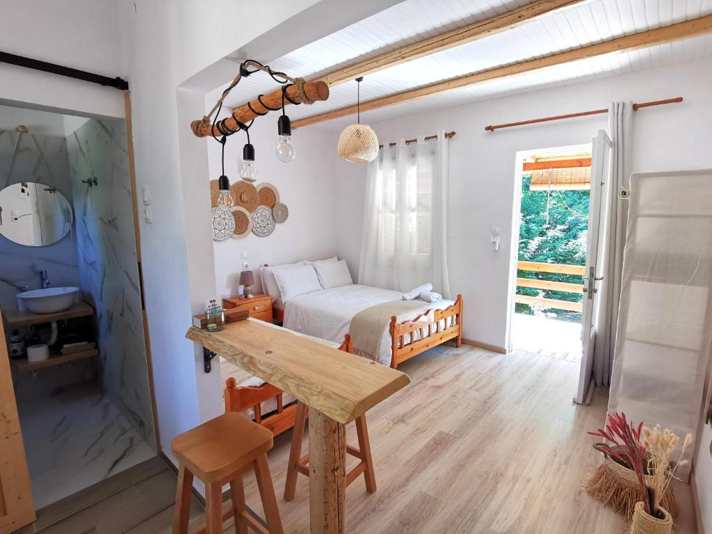 a kitchen with a table and a bed in a room at Sotiria Apartments in Kókkinon Nerón