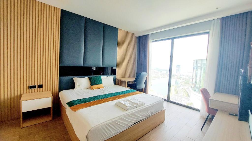 a hotel room with a bed and a large window at Sweet Home - Duplex 3BRS Citadines Hạ Long in Ha Long