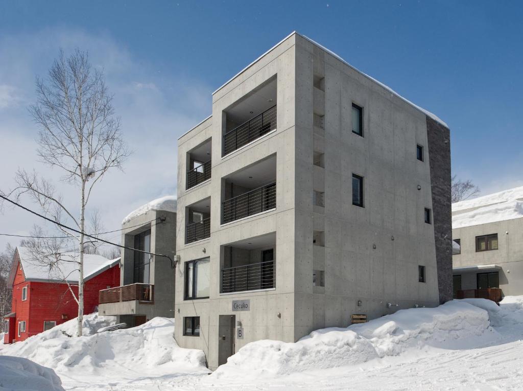 a concrete building in the snow with snow around it at Cecuko A in Kutchan
