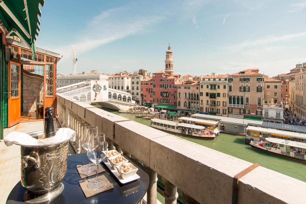 a balcony with a view of a river and buildings at Rialto Terrace on the Grand Canal in Venice