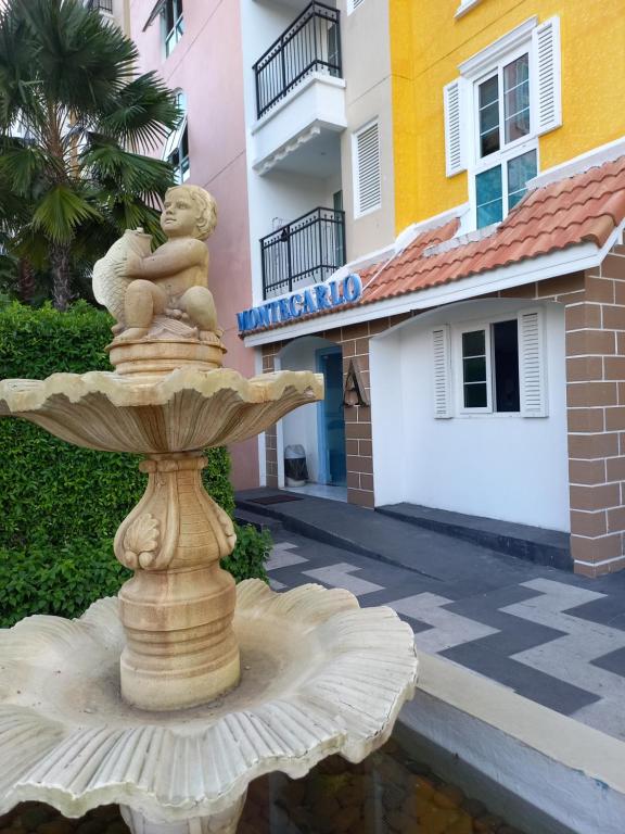 a statue of a fountain in front of a building at Seven Seas Cote d'Azur, Jomtien Beach Pattaya in Na Jomtien