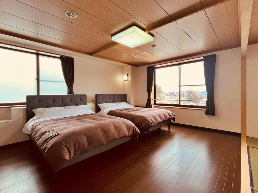 Postel nebo postele na pokoji v ubytování Hotel Omodaka