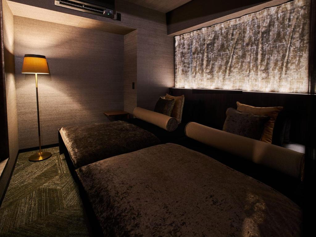 Postel nebo postele na pokoji v ubytování Roppongi Hotel S
